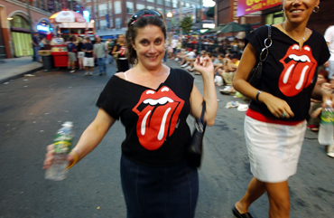 Some Rolling Stones fans wearing T-shirts with the famous logo.