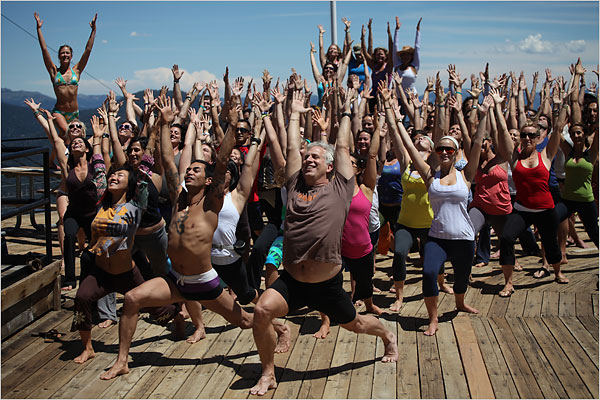 John Friend, center, a famous yoga instructor, leads a session at the Wanderlust festival at Lake Tahoe. (c) Jon Hyde for NY Times.
